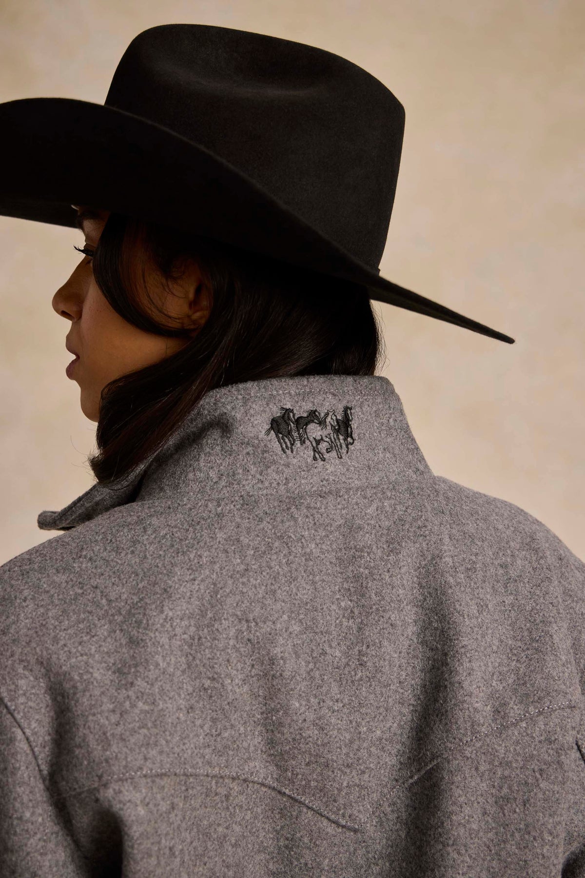 Heather gray wool jacket with embroidered horse logo on the back of the collar
