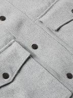 Light gray wool ranch jacket detail with round dark buttons and seam stitching