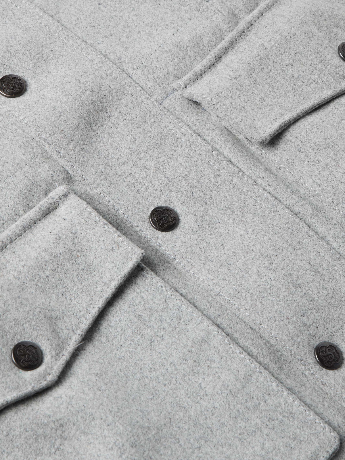 Light gray wool ranch jacket detail with round dark buttons and seam stitching