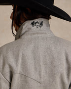 Light gray wool rancher jacket back panel with horse logo and curved seam