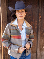 Women’s striped jacket with tan leather-look collar, chest snap buttons, and dark button front