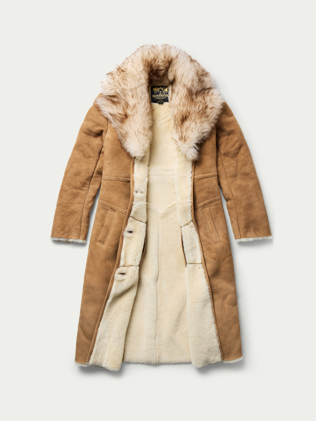 Women’s chestnut shearling coat with fur-lined interior and long button-front design