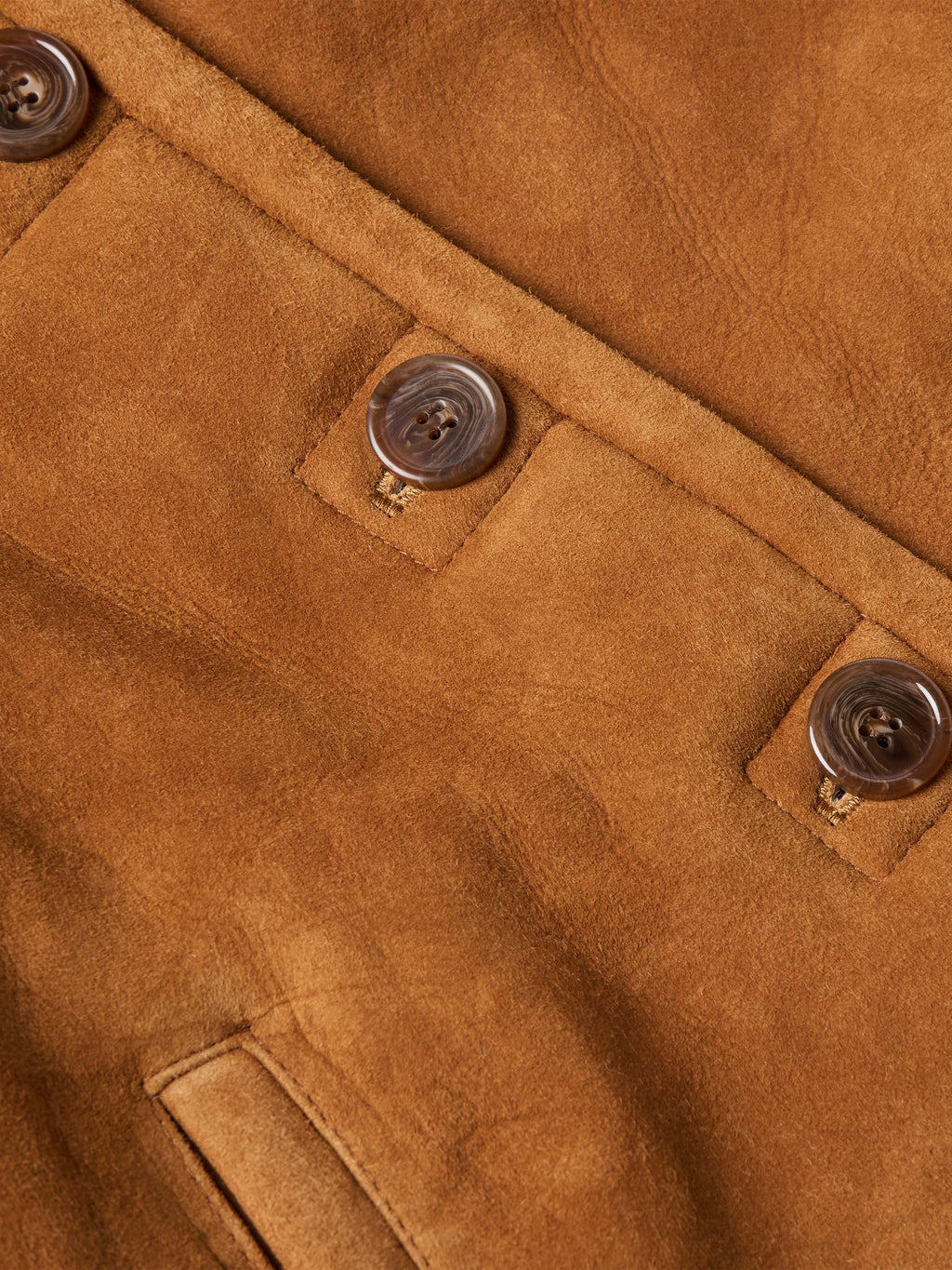 Brown shearling jacket with button placket and stitched chest pockets detail
