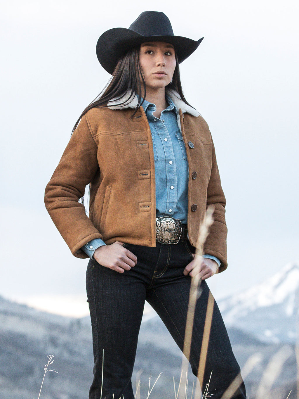 Brown shearling jacket with tan sherpa collar and button front, worn with jeans