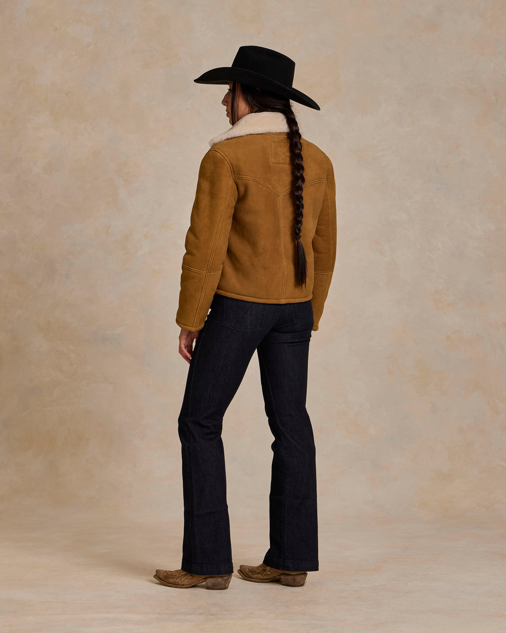 Brown shearling jacket back view with sherpa collar and seam detailing