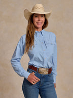 Sky blue western snap shirt with button front and long sleeves on model