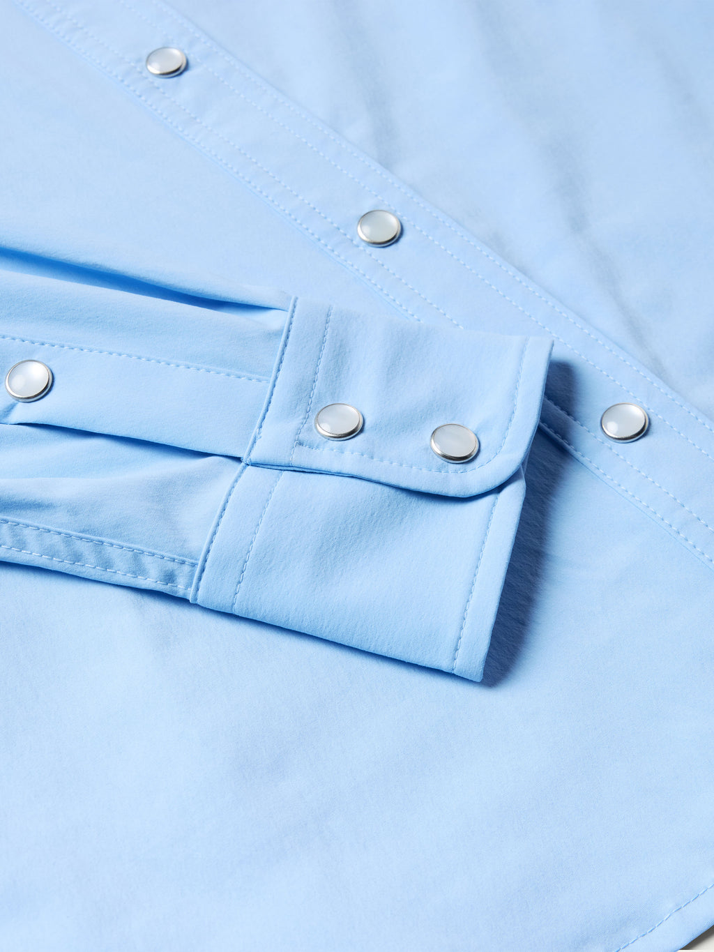 Women’s sky blue snap shirt cuff with metal snaps and adjustable placket