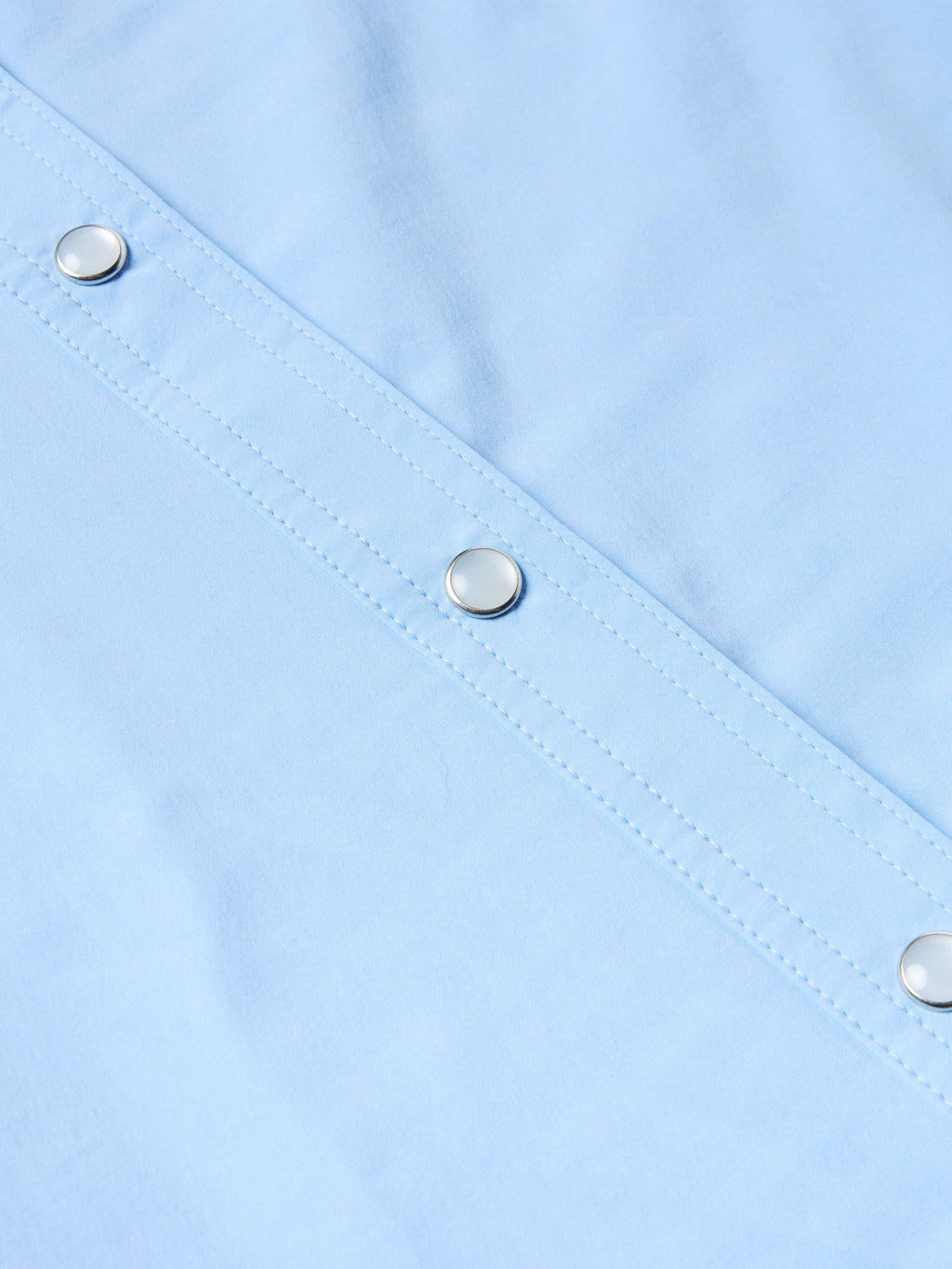 Women’s sky blue Western snap shirt with metal snap buttons along front