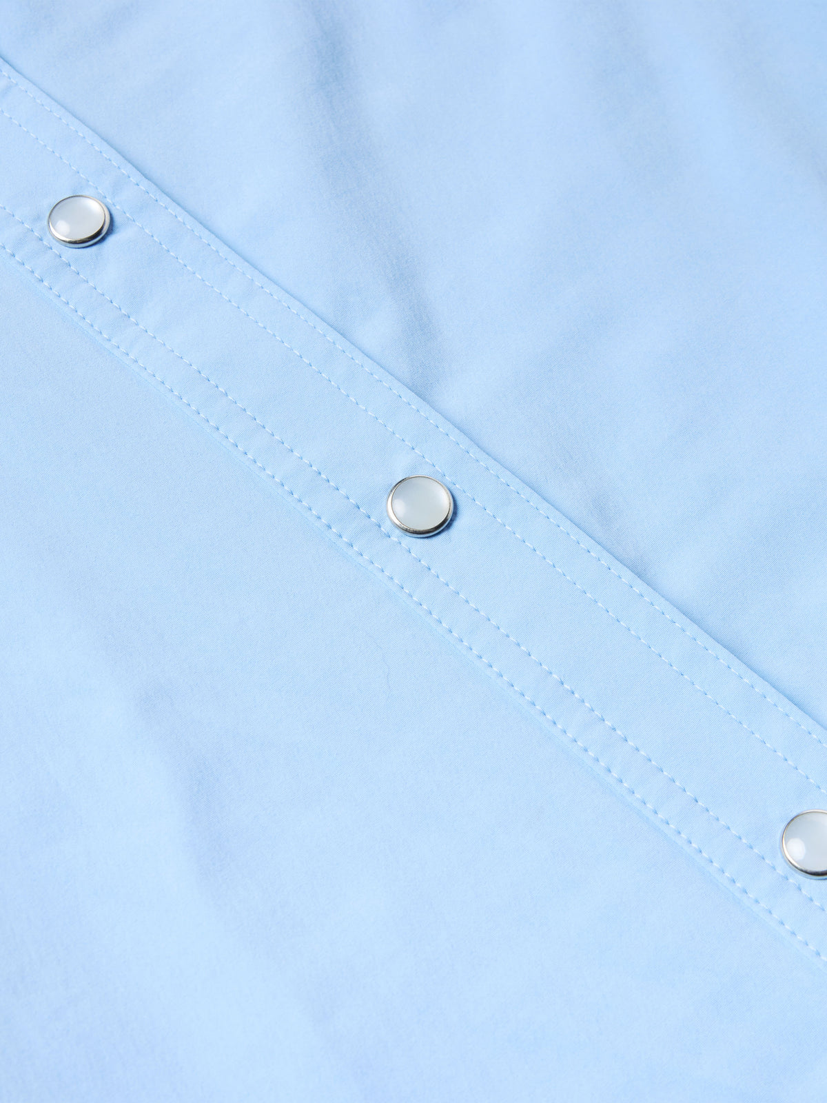 Women’s sky blue Western snap shirt with metal snap buttons along front