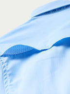 Women’s sky blue snap shirt shoulder seam and collar underside detail