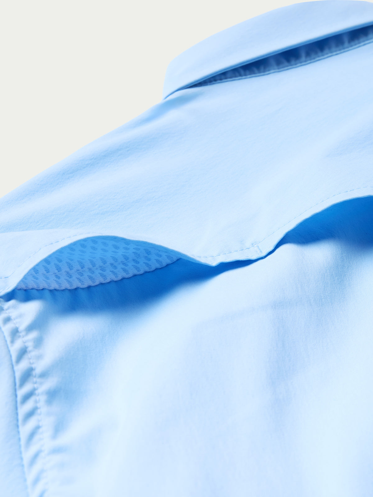 Women’s sky blue snap shirt shoulder seam and collar underside detail