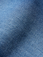 Medium indigo denim fabric with visible twill texture