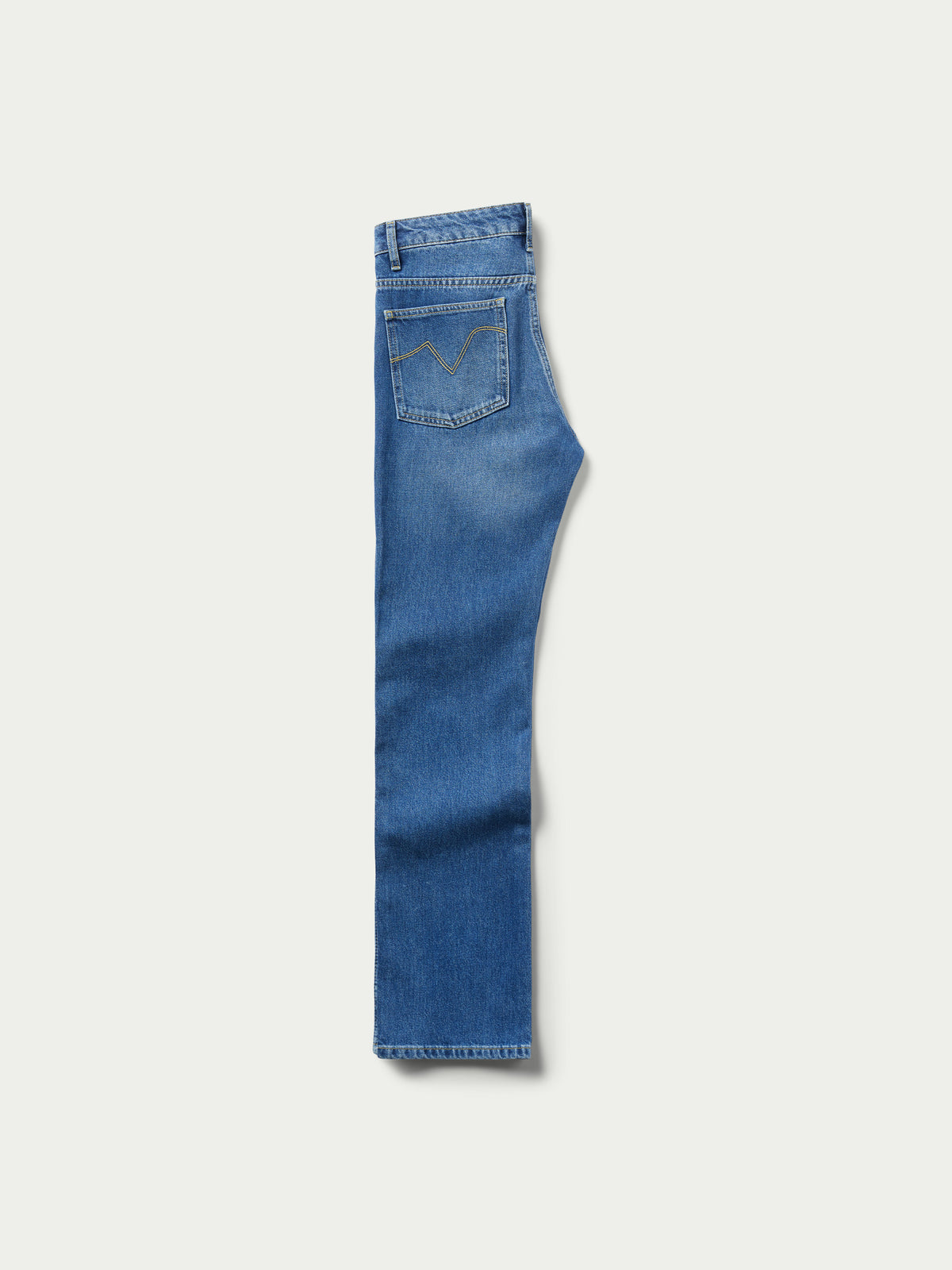 Medium indigo jeans side view with stitched seam detail