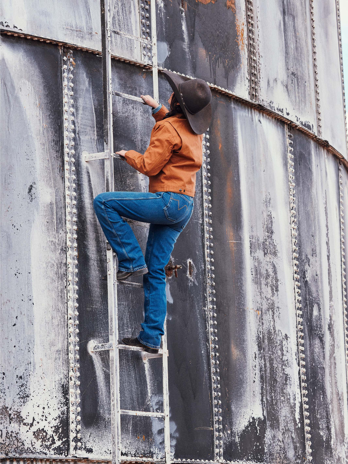 Medium indigo jeans worn by a person, denim with visible front stitching