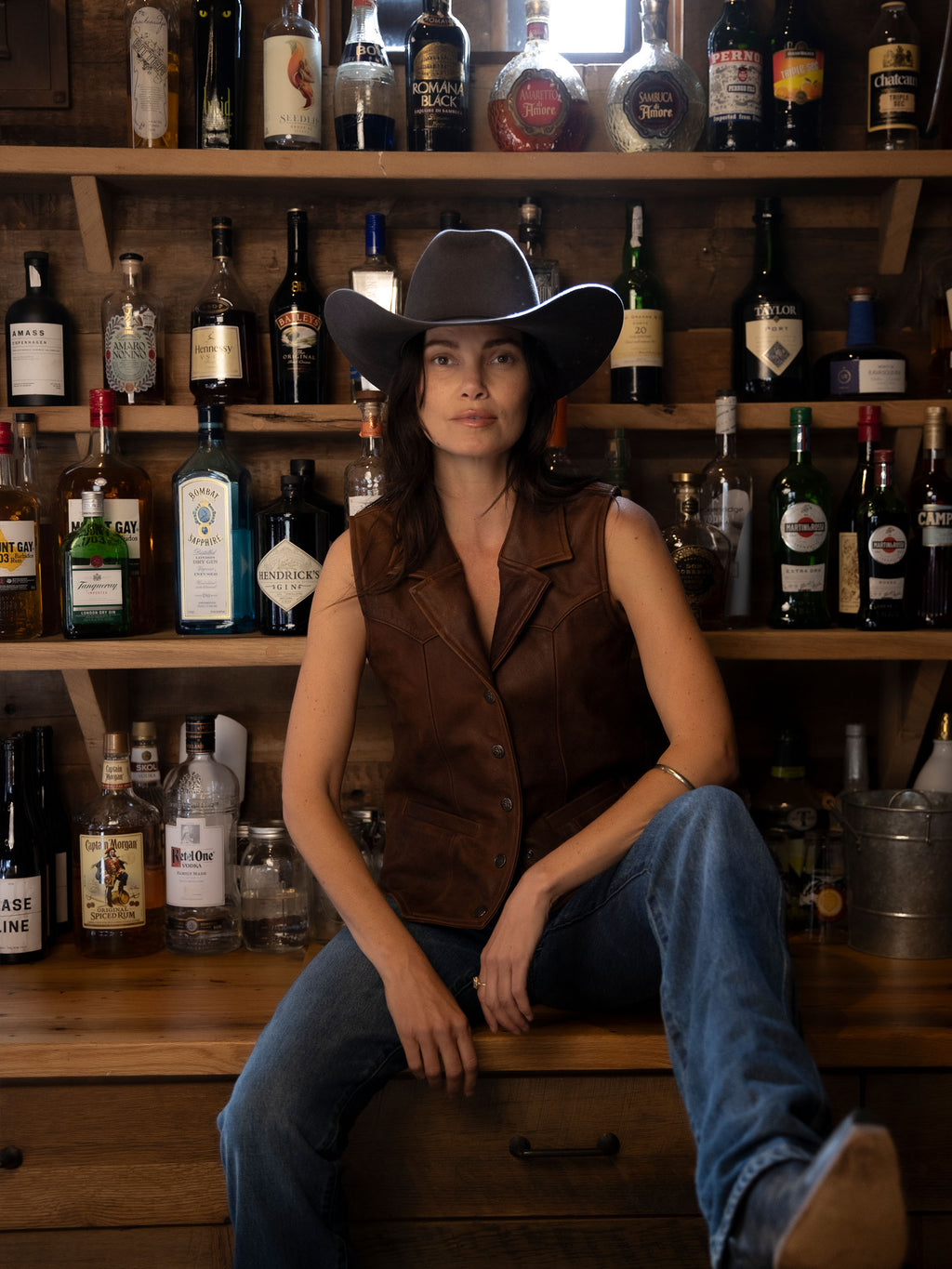 Women's whiskey-brown leather vest with two chest pockets and button front