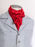 Red jacquard wild rag scarf, tied around neck with decorative knot