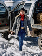 Red wild rag scarf tied at the neck on a person in a hat