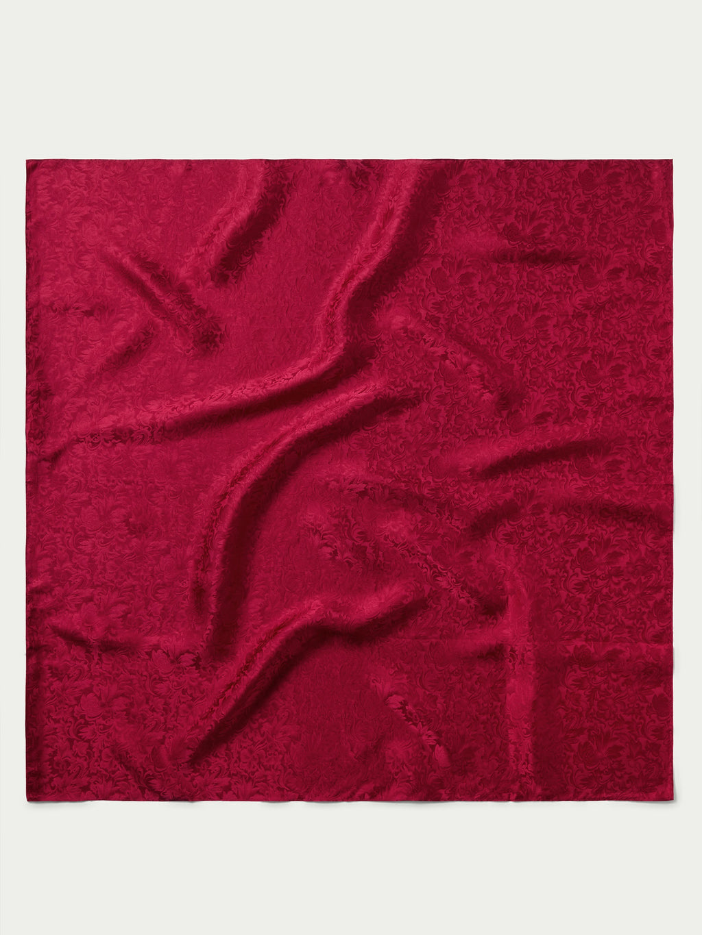 Burgundy jacquard fabric swatch with ornamental pattern
