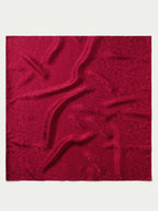 Burgundy jacquard fabric swatch with ornamental pattern