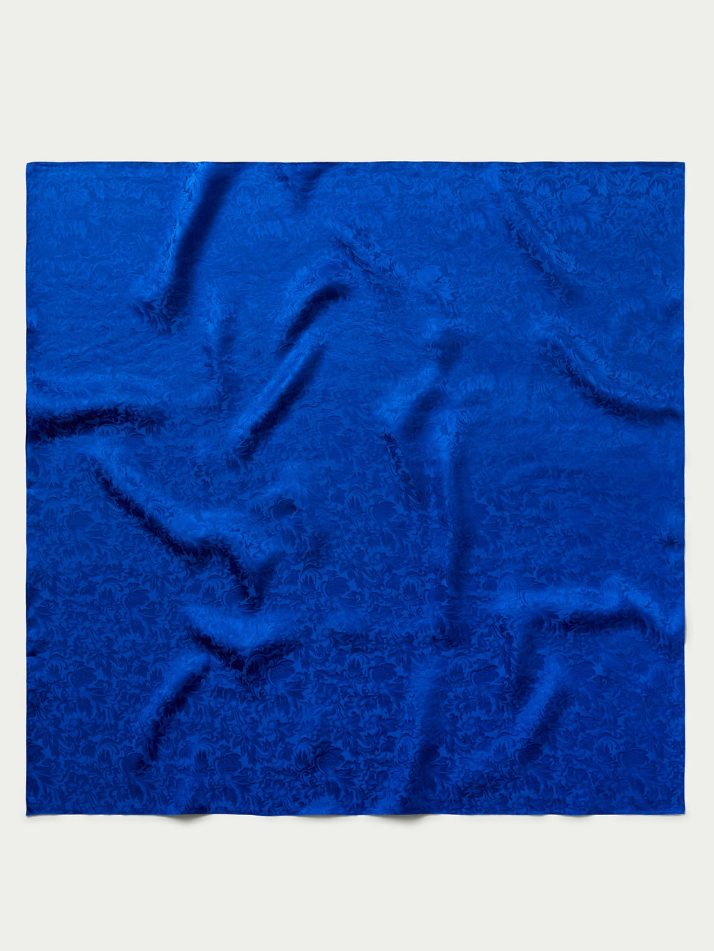 Royal blue jacquard wild rag fabric square with swirling embossed pattern