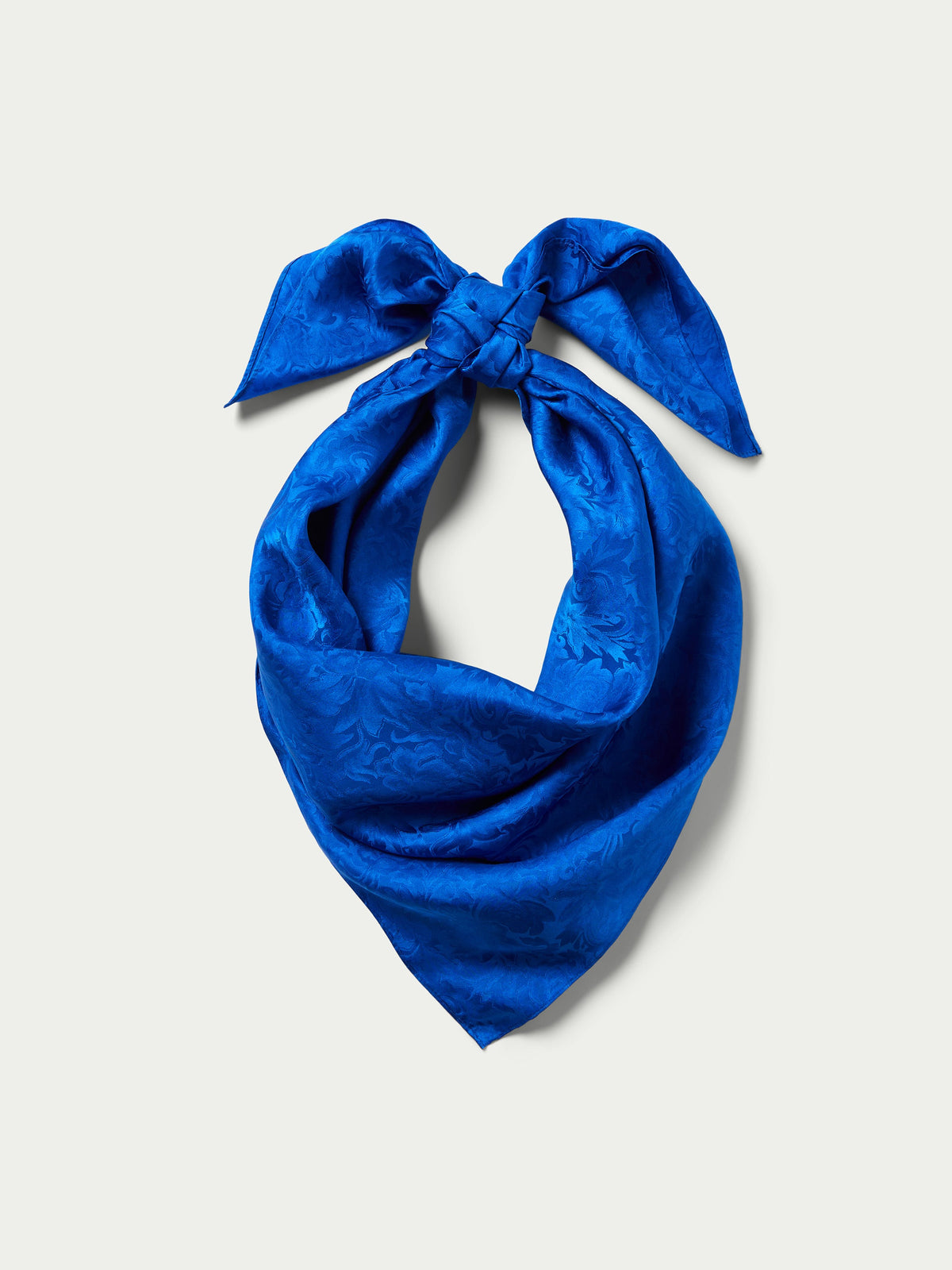 Royal blue jacquard wild rag scarf with gathered bow and draped knot shape