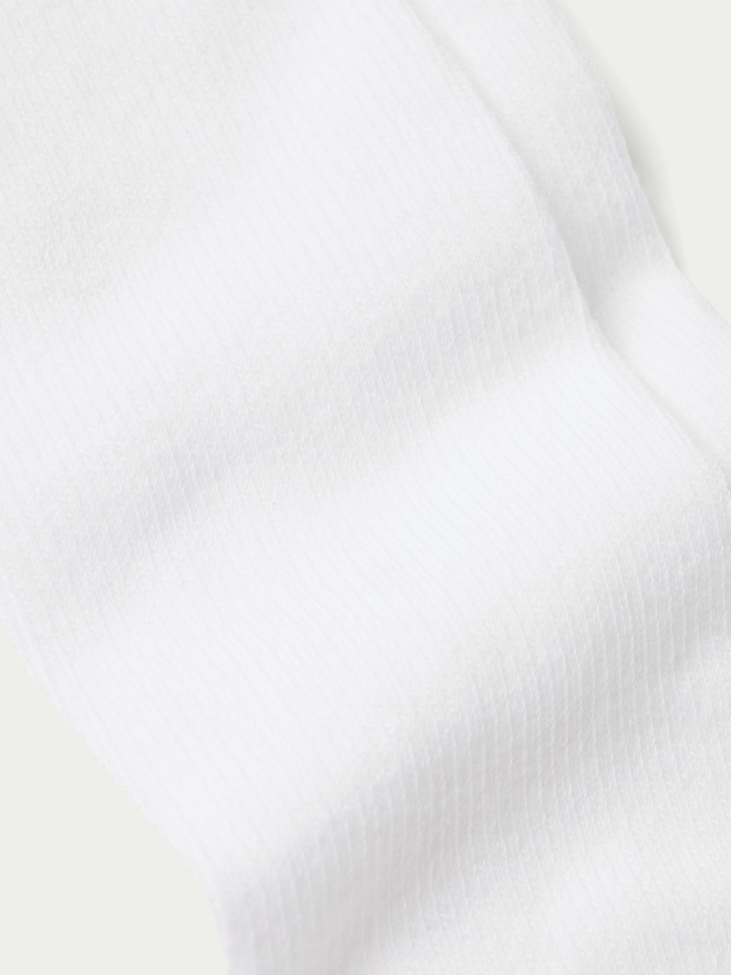 White boot sock with ribbed cuff and smooth knit texture