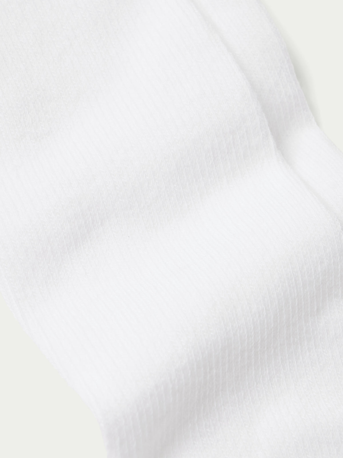 White boot sock with ribbed cuff and smooth knit texture