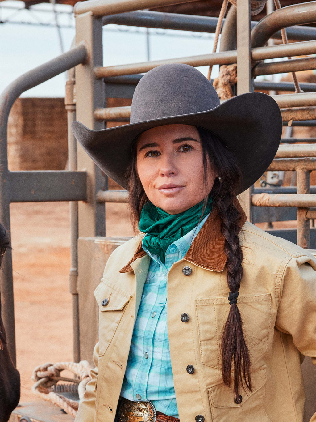 Emerald jacquard wild rag worn as a neck scarf under a cowboy hat