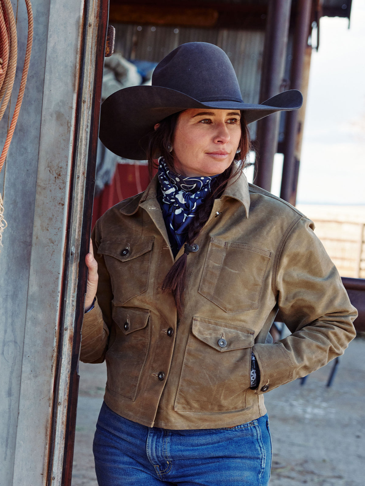 Navy bandana wild rag worn at the neck under a dark cowboy hat