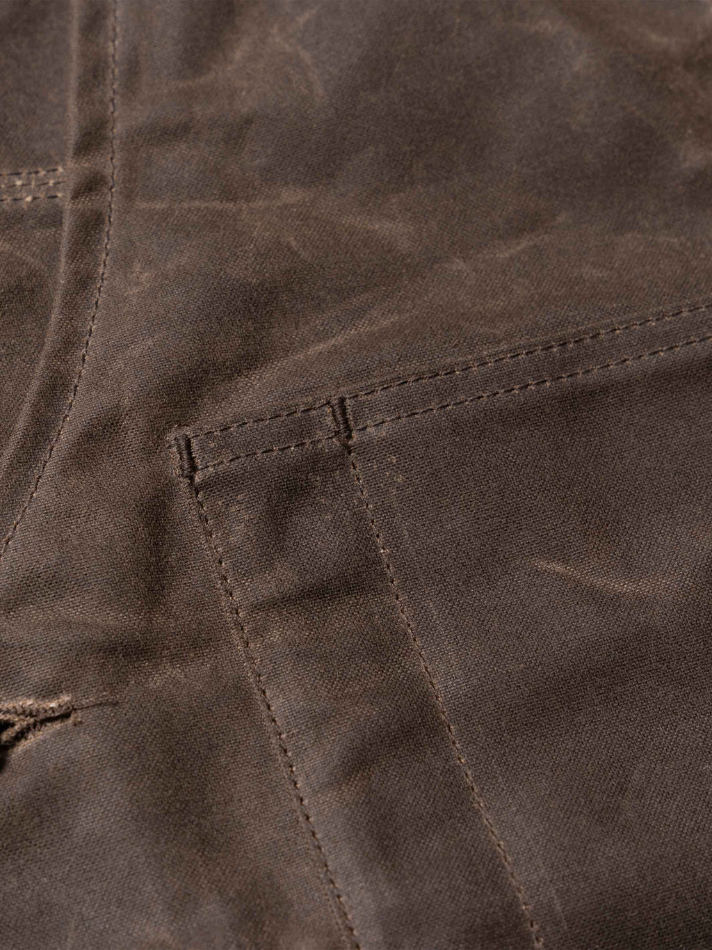 Mesquite vest pocket stitching and textured dark brown fabric detail