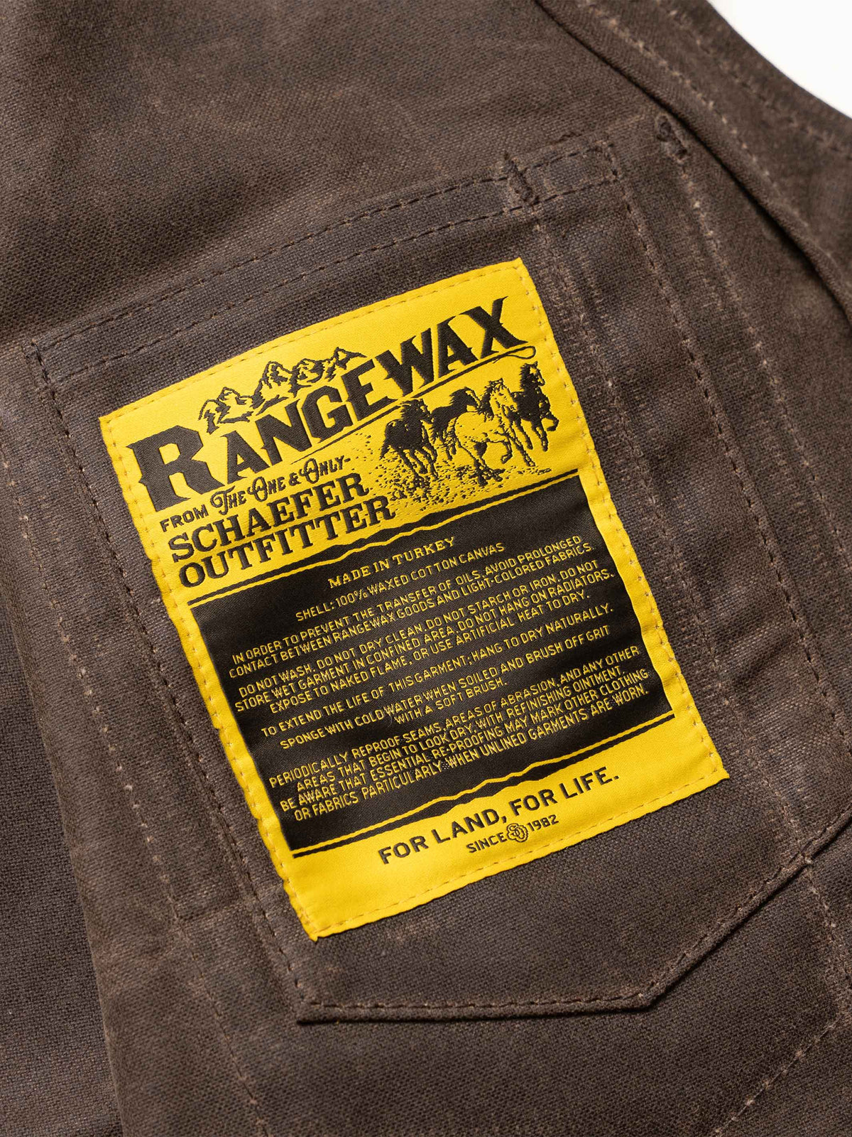 Mesquite vest yellow brand label on front pocket area