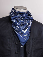 Navy bandana wild rag with white paisley and scroll pattern, draped over collar
